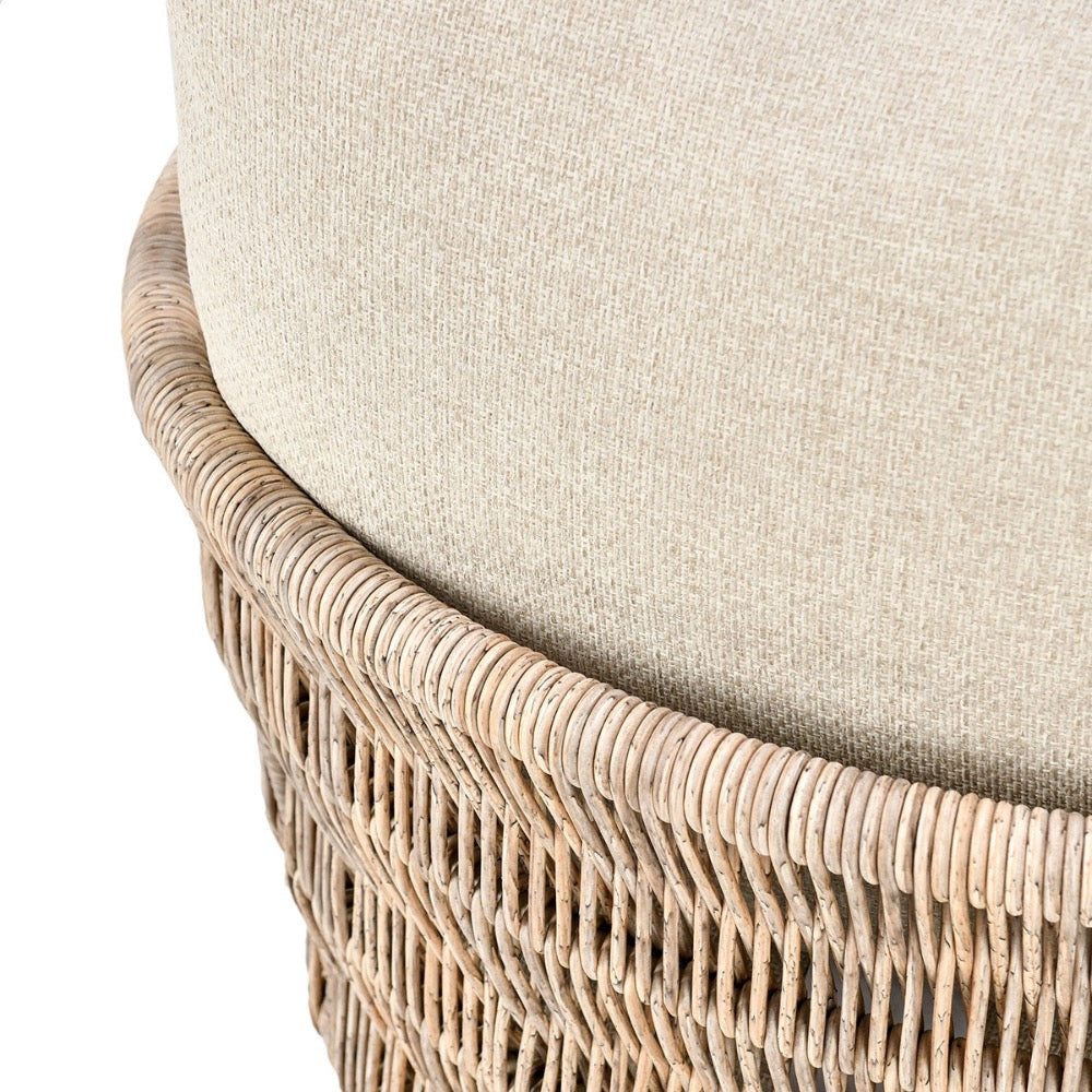 Close-up of a chair with wicker frame and beige cushion on a white background