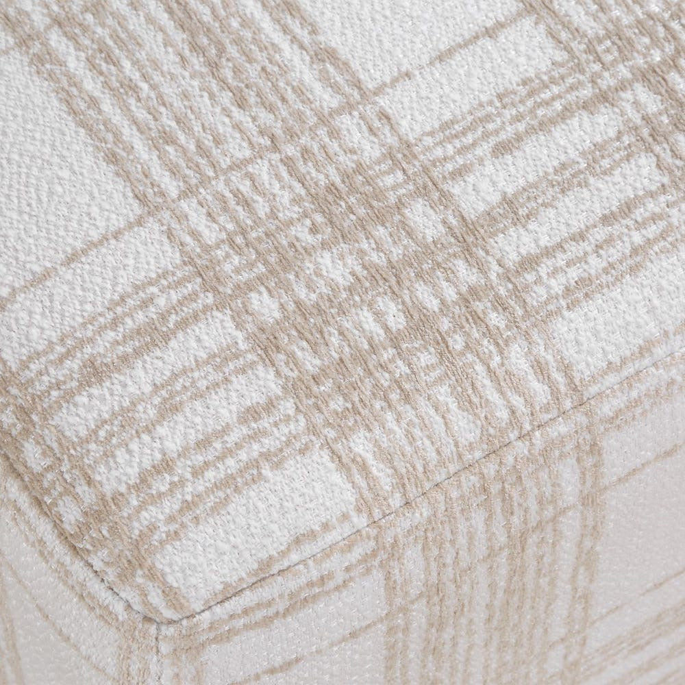 Close-up of a textured fabric with a beige and off-white plaid pattern.