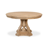 Round wooden table with decorative legs on a white background