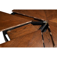The Sarreid, Ltd. Casual Paldao Finish Medium Jupe Dining Table features a round top and geometric pedestal base.