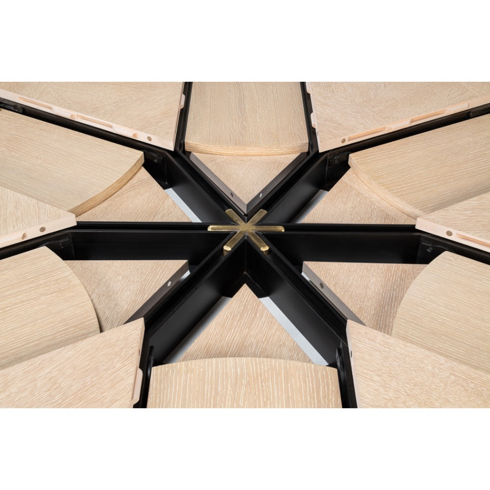 Close-up of the Giselle Bleached Oak Finish Medium Jupe Dining Table by Sarreid, Ltd. with a black metal frame.
