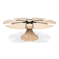 The Giselle Bleached Oak Jupe Dining Table by Sarreid, Ltd. features a round extendable top and pedestal base.