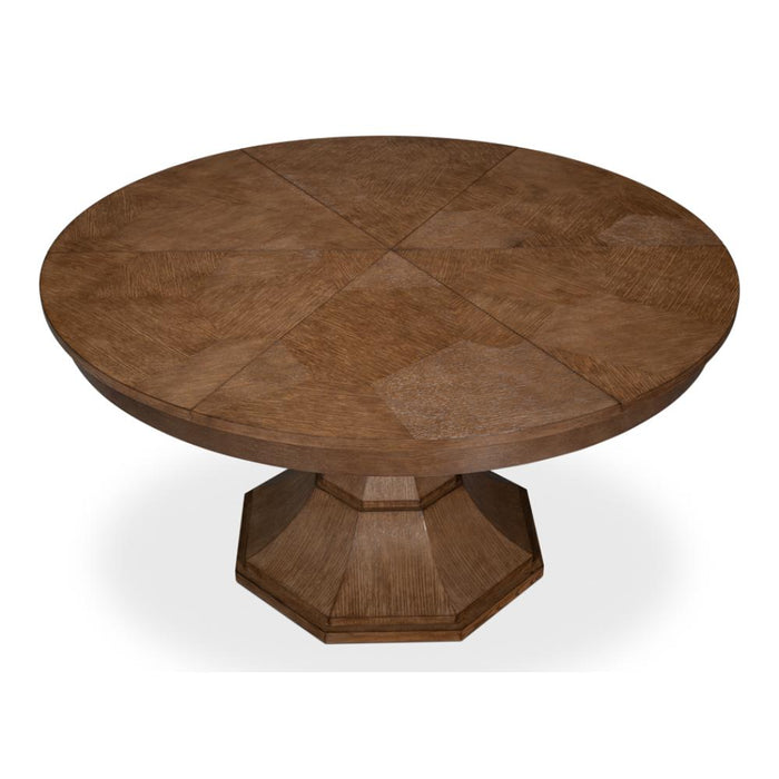 A round wooden dining table with a multi-panel tabletop and a geometric octagonal pedestal base, shown on a white background.