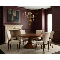 Dining room with wooden table and chairs, chandelier, and fireplace.