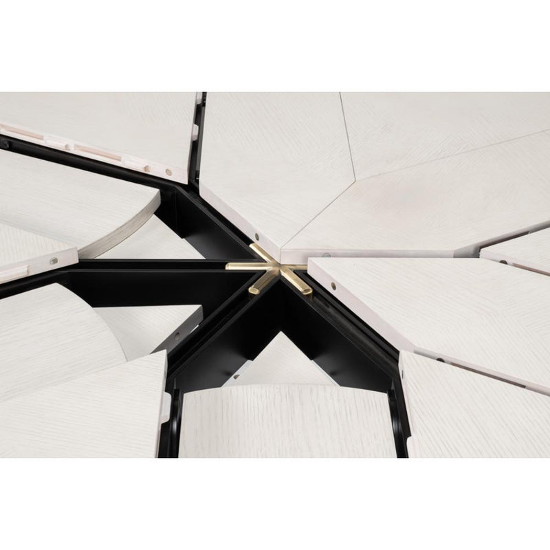 Geometric panels and metal hinges create a star-like design on the Giselle Jupe Table by Sarreid, Ltd.