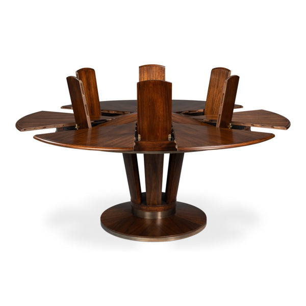 The Soho Brown Finish Large Jupe Dining Table by Sarreid, Ltd. features six fold-out leaves and a central pedestal.