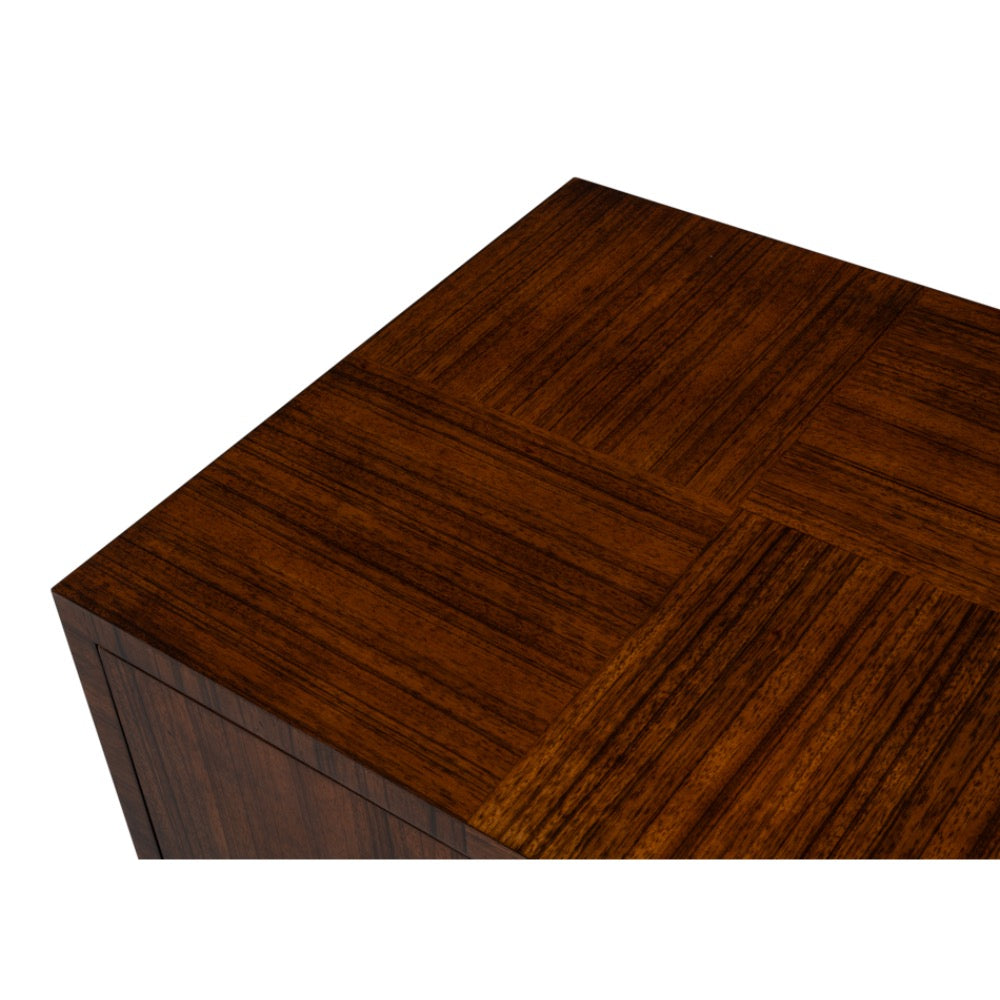 Close-up of a dark brown wood grain surface with a parquet-style inlay pattern, shown against a plain white background.