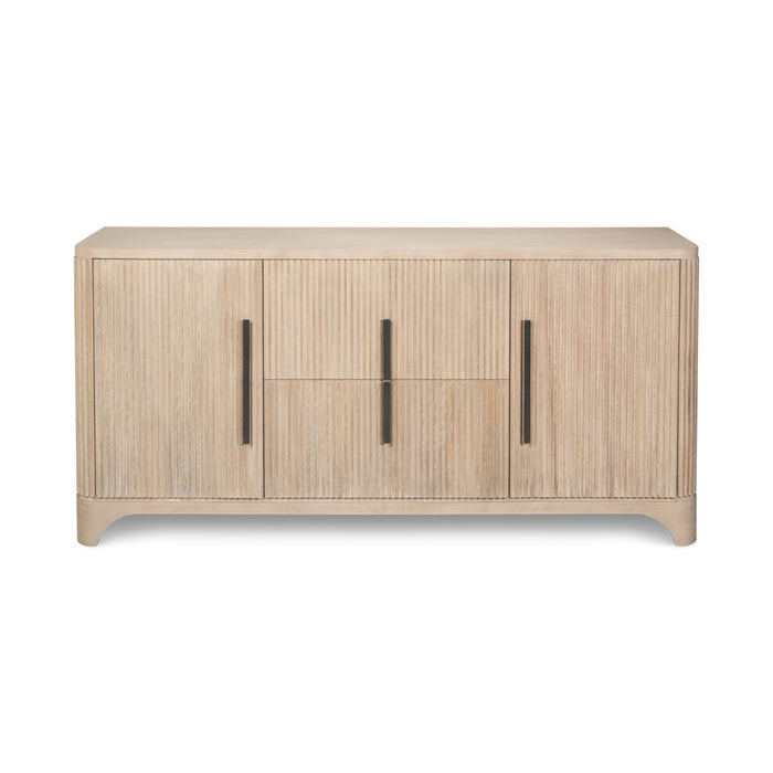 A modern light oak wood sideboard with three doors, vertical fluted grain, and slim dark metal handles, shown against a plain white background.