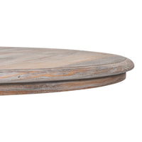 Close-up of a round wooden table top with a distressed, weathered finish showing natural wood grain and light brown tones, isolated on a white background.