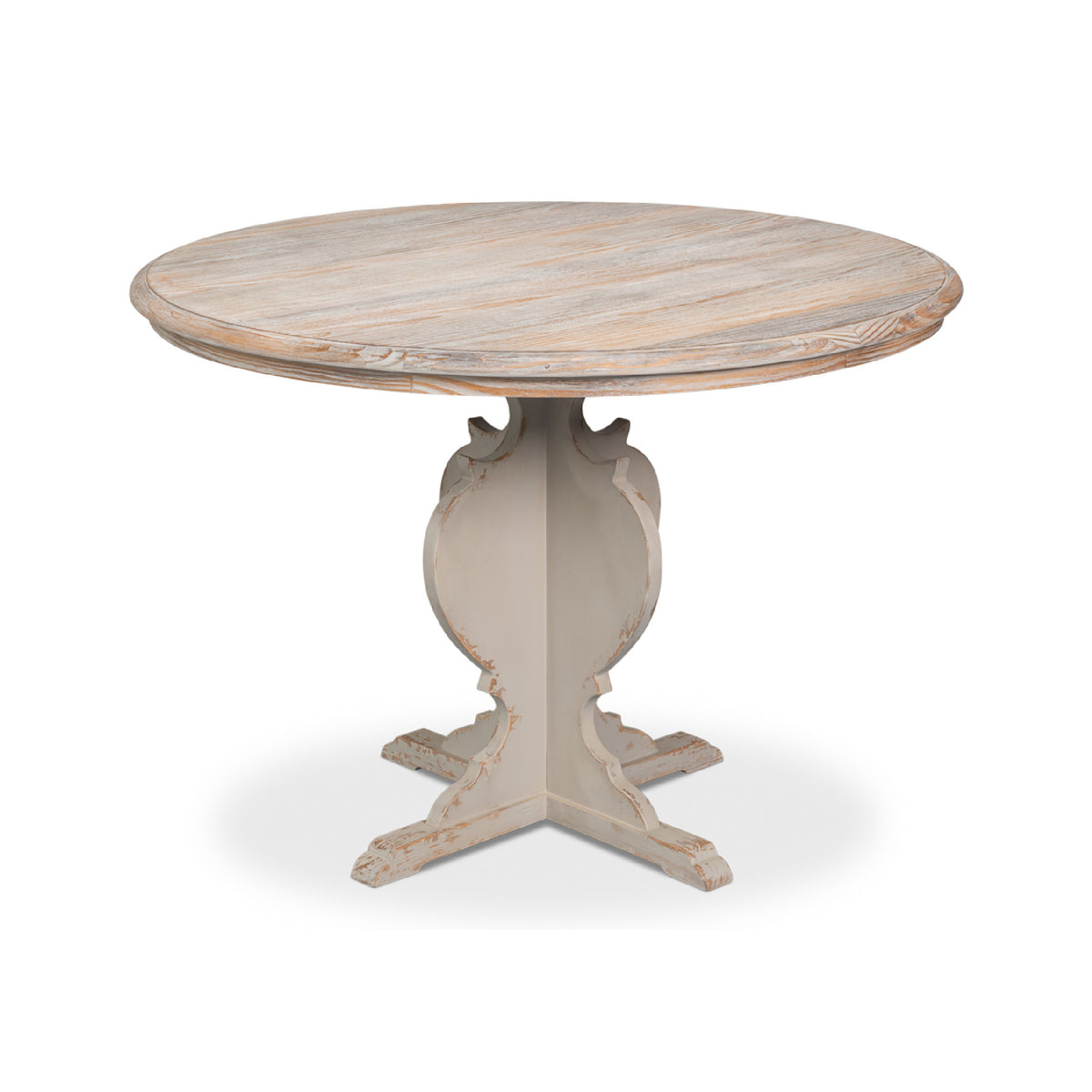 A round dining table with a distressed light wood top and a carved pedestal base in a light gray finish, shown on a white background.