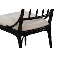 Chair with dark wooden frame and beige cushion on a white background