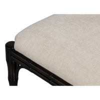 Chair with dark wooden frame and beige cushion on a white background