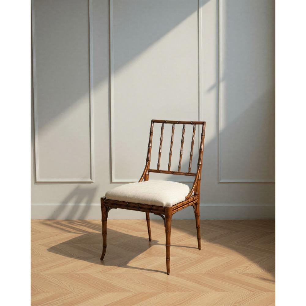 The Elora Palladio Stained Dining Chair set by Sarreid, Ltd. pairs faux-bamboo style with upholstered seats in sunlight.