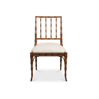 A single dining chair with a brown bamboo-look frame, a vertical slatted backrest, and a light beige upholstered seat cushion, shown against a plain white background.