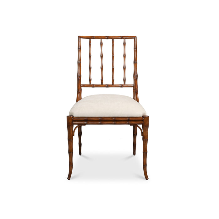 A single dining chair with a brown bamboo-look frame, a vertical slatted backrest, and a light beige upholstered seat cushion, shown against a plain white background.
