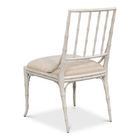 White rattan chair with beige cushion on a white background