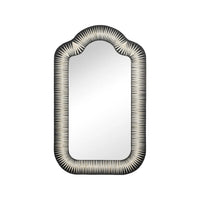 An arched rectangular wall mirror with a black and white sunburst patterned frame, shown against a plain white background.