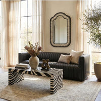 Modern living room with black sofa, armchair, zebra table, and Sarreid's Meridian Bone Inlay Mirror by the windows.
