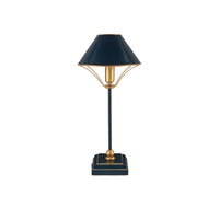 A table lamp with a dark navy blue shade and base accented with gold trim and gold-toned metal details, set against a plain white background.
