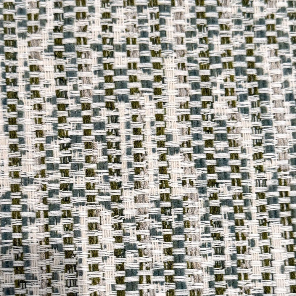 Close-up of a textured fabric with a geometric pattern in shades of gray and white.