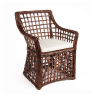 Wicker armchair with a white cushion on a white background
