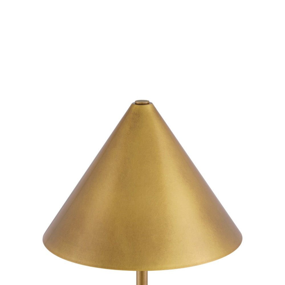 A close-up of a table lamp shade in a warm brass or gold finish, shown against a plain white background.