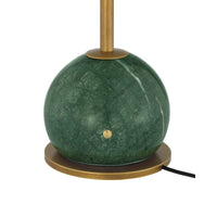 A modern table lamp featuring a spherical green marble shade with a small brass button detail, supported by a round brass base and a vertical brass stem, shown against a plain white background.