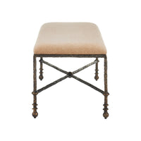 Stool showing a tan woven fabric cushion on a distressed dark bronze metal frame with a textured, branch-like finish.