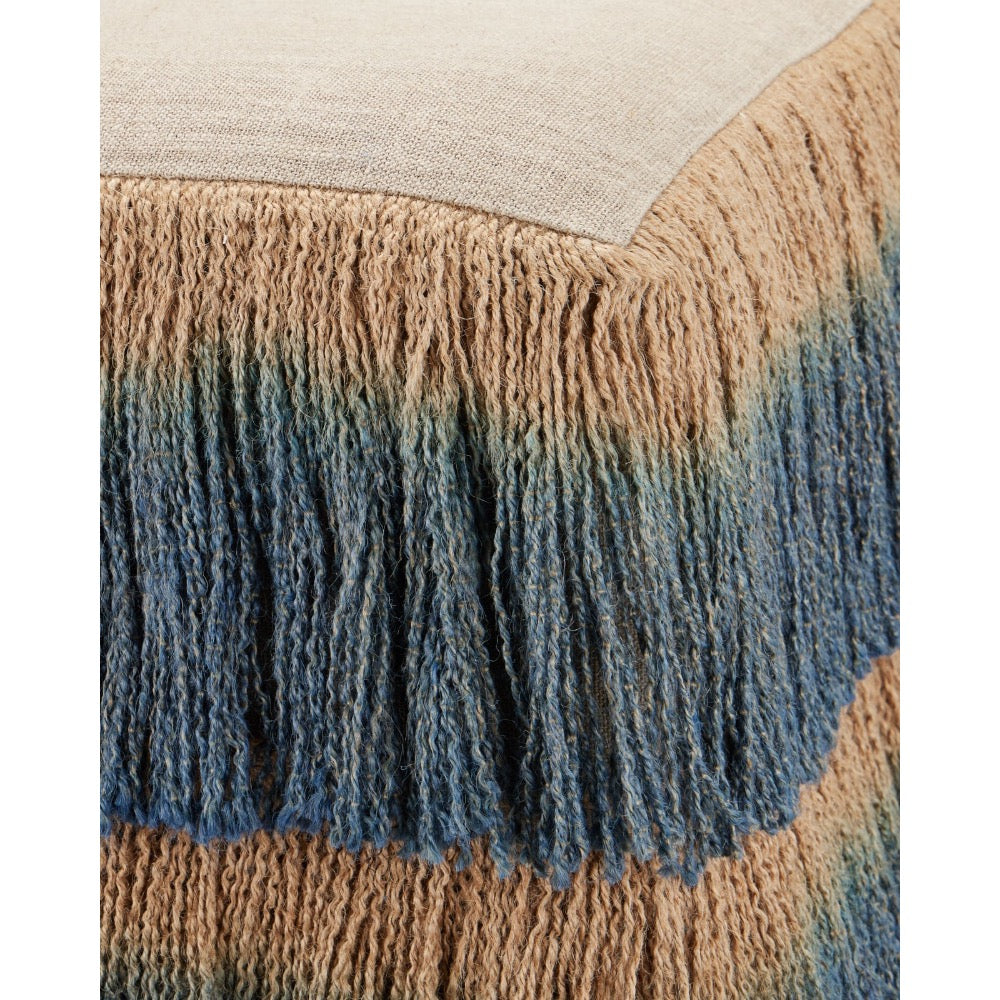 Close up of corner view of jute and blue fringe ottoman