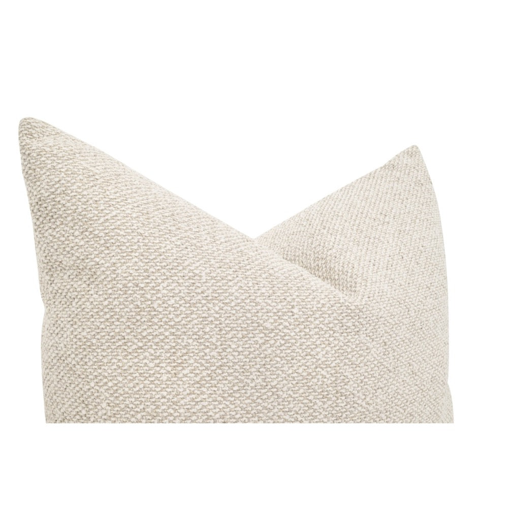 Textured beige pillow on a white background