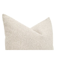 Textured beige pillow on a white background
