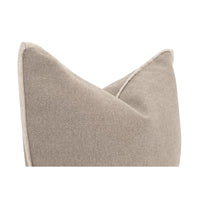 A close-up of a textured throw pillow in a warm taupe-beige color, showing the fabric weave and a subtle light-colored piping detail along the edge, set against a solid white background.