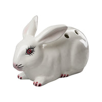 White ceramic rabbit with decorative features on a white background