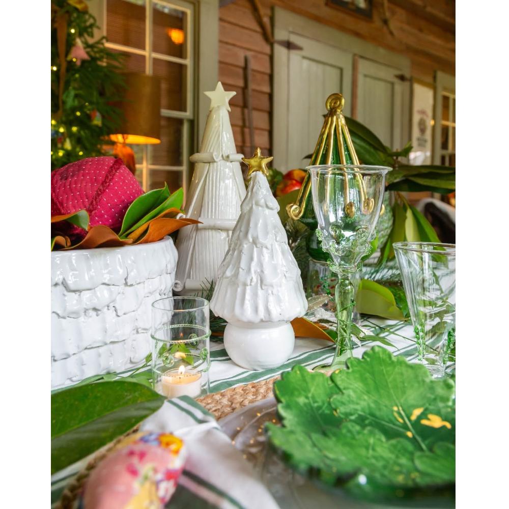 Abigails Ceramic White Christmas Tree with Gold Star centered on a decorated dining table.