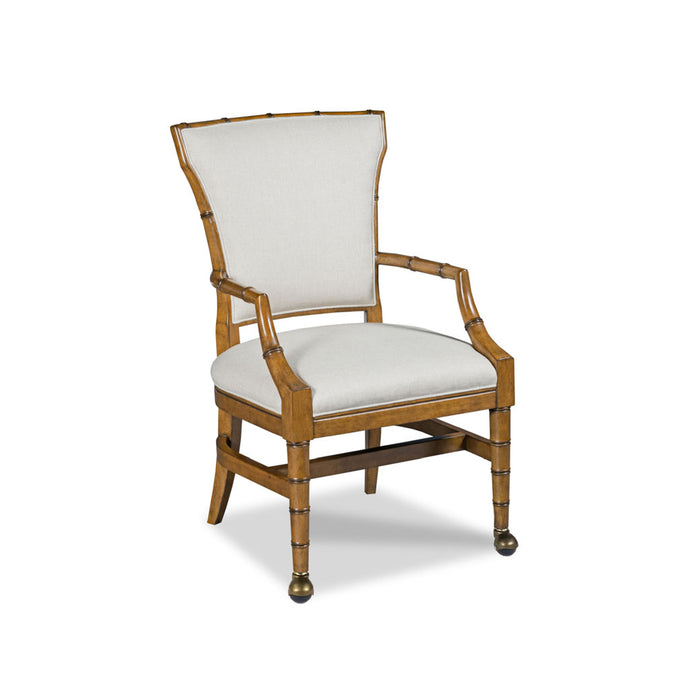 A single upholstered armchair with a bamboo-style wooden frame and light beige fabric cushions, shown on a plain white background.