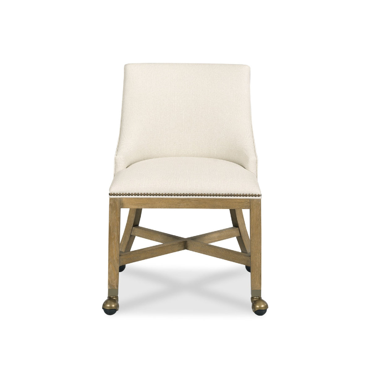 An upholstered accent chair with a cream fabric seat and backrest, a natural wood frame, and brass nailhead trim on the front apron, shown against a plain white background.