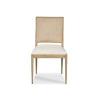 A light wood dining chair with a woven cane backrest and a cream upholstered seat, shown against a plain white background.
