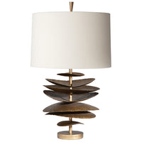 Decorative table lamp with tiered wooden base and white shade on a white background