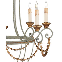 Close up of decorative chandelier with gold and bronze accents on a white background