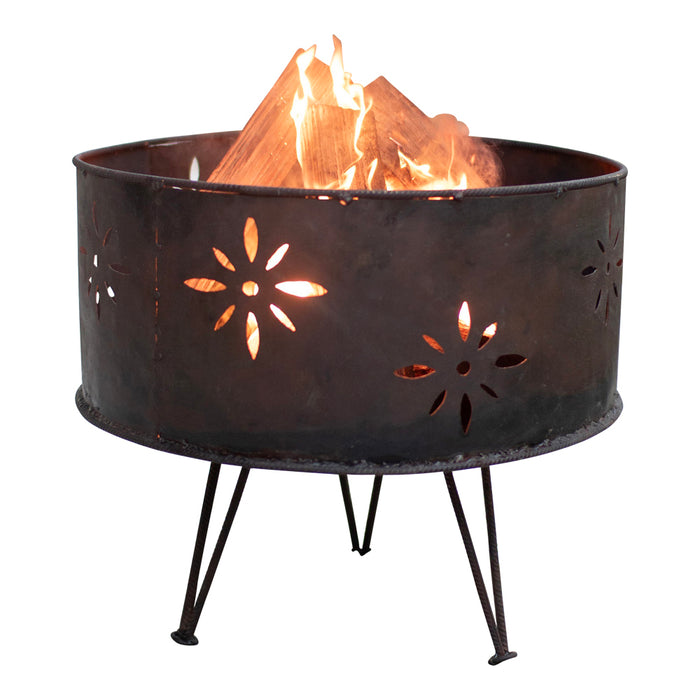 Decorative metal fire pit with floral cutouts on a white background