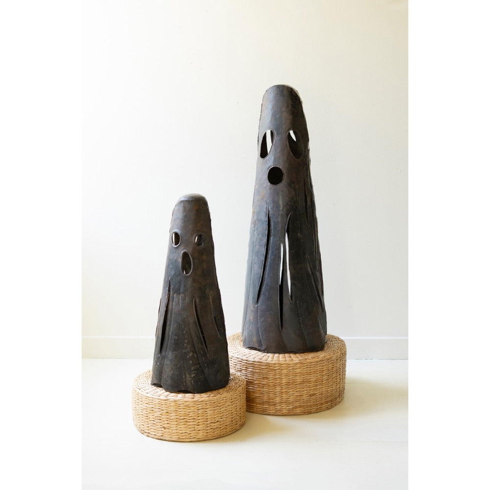 Set of 2 Rustic Iron Ghost Luminaries by Kalalou with cut-out faces, displayed on round woven baskets.