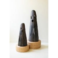 Set of 2 Rustic Iron Ghost Luminaries by Kalalou with cut-out faces, displayed on round woven baskets.