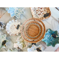Collection of ceramic plates and woven basket 