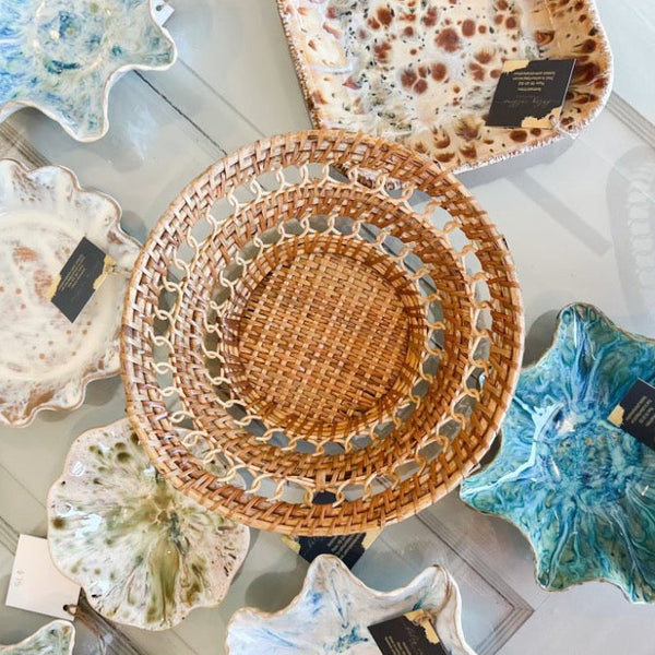 Collection of ceramic plates and woven basket 