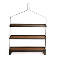 A rustic three-tier wooden shelf with a black metal wire hanger-style frame and feet, shown against a plain white background.