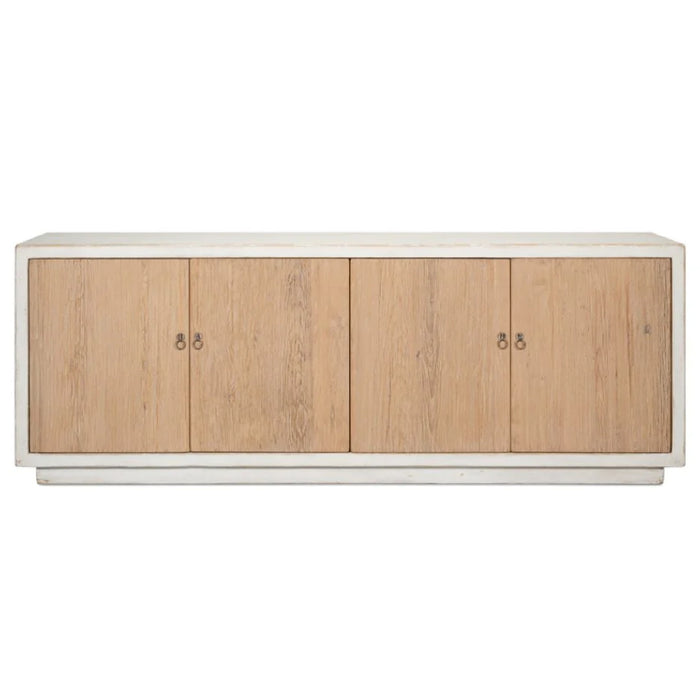 The Antiqued Natural Pine Cabinet by Sarreid, Ltd. features four light wood doors and a minimalist white frame design.