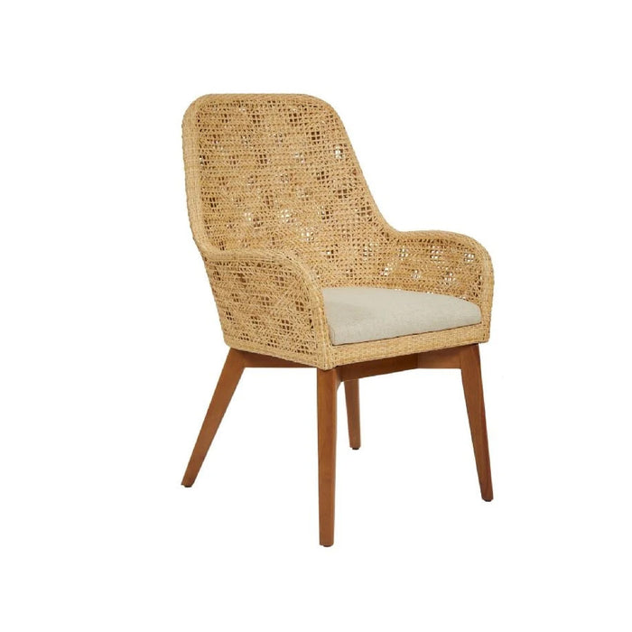 The Ava Natural Rattan Armchair by Kenian features wooden legs, a cushioned seat, and woven details.