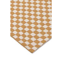 A close-up of a woven rug or mat with a tan and off-white checkerboard pattern, shown against a plain white background.