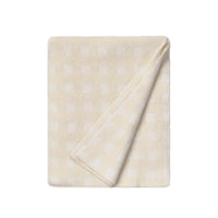 A folded cream-colored cotton blanket with a subtle white gingham check pattern, shown on a solid white background.