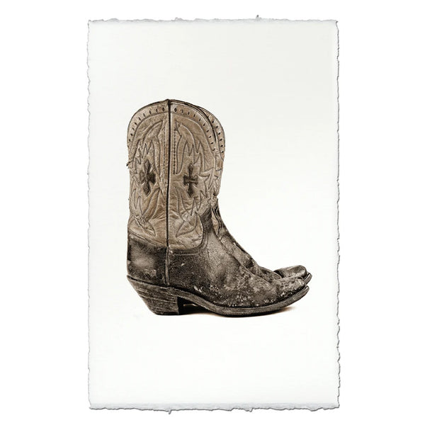 Art print featuring a sepia-toned photograph of a distressed western cowboy boot, displayed on a white sheet of paper with torn edges against a white background.